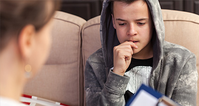 a teenager in a therapy session with a therapist 